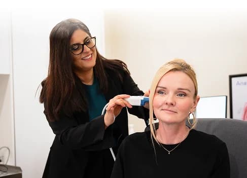 Audiologist performing hearing assessment
