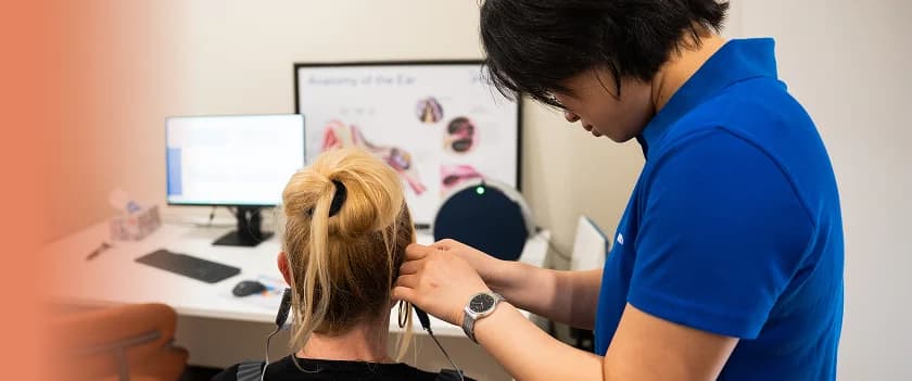 Audiologist performing hearing assessment
