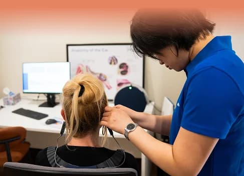 Audiologist performing hearing assessment