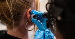 Clinician performing microsuction ear wax removal
