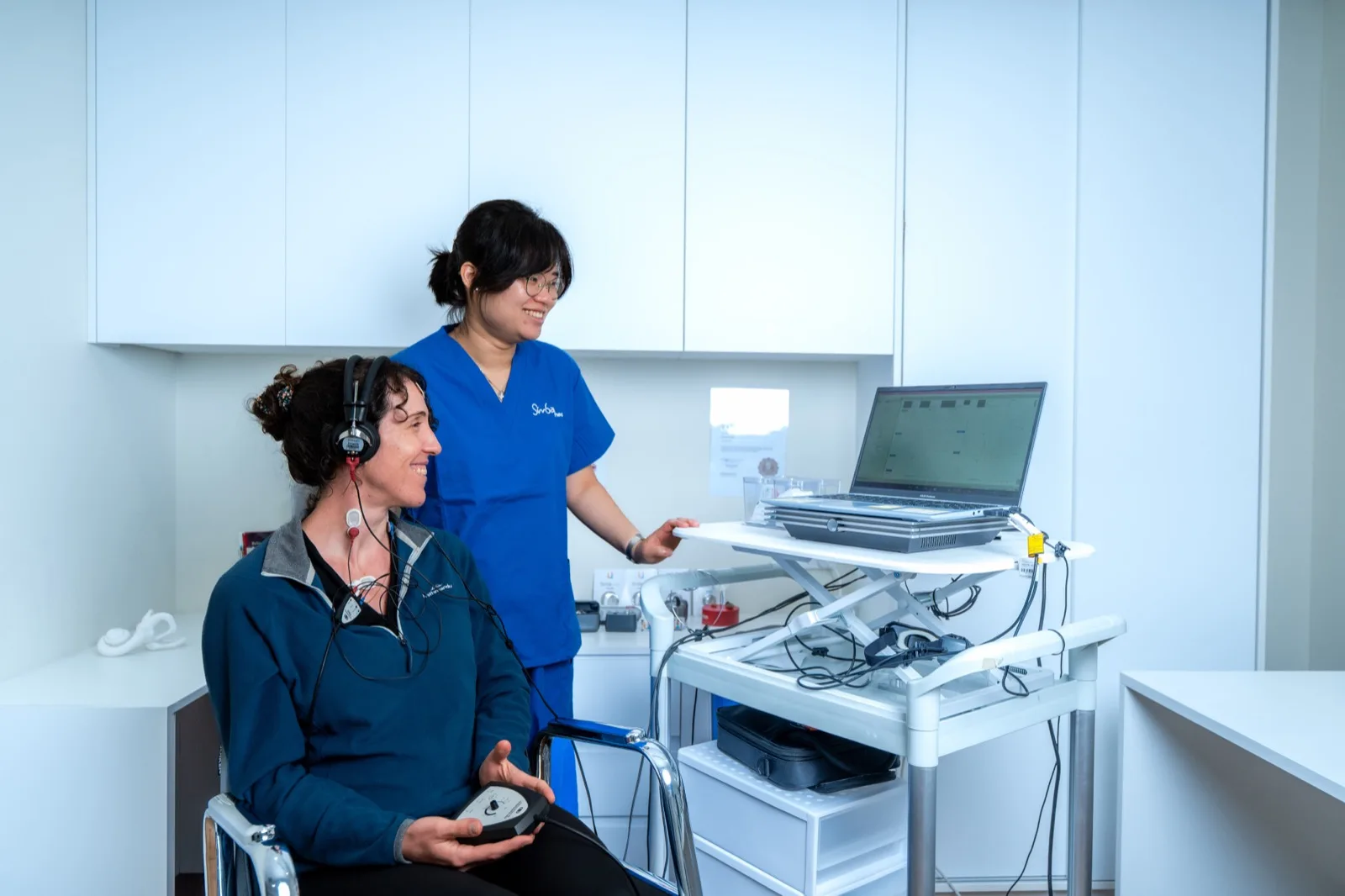 A Simba Health audiologist running a hearing assessment from the audiometer console