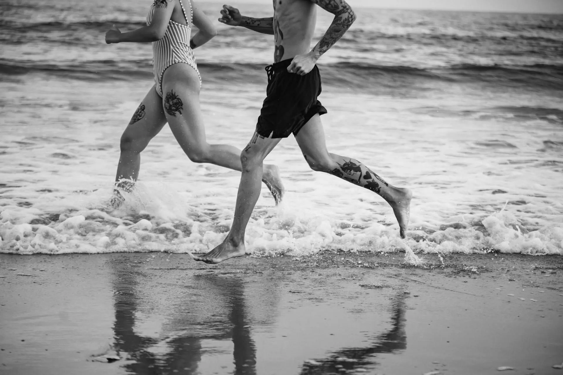 Two people running on the beach